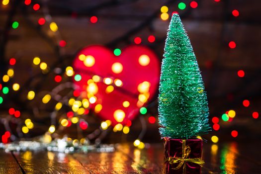 Decorations and ornaments in a colorful Christmas composition isolated on background of blurred lights.