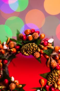 Colorful decorated Christmas wreaths isolated on background of blurred lights.