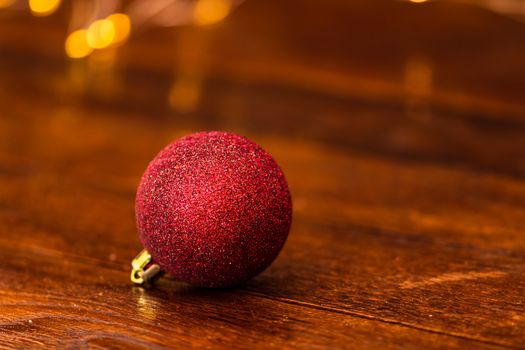 Colorful Christmas ball isolated on blurred and shiny background of lights. Christmas baubles isolated.