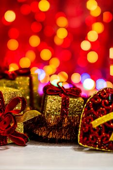 Decorations and ornaments in a colorful Christmas composition isolated on background of blurred lights.