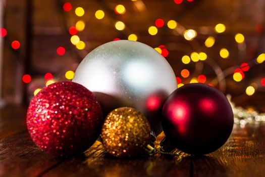 Decorations and ornaments in a colorful Christmas composition isolated on background of blurred lights.