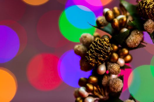 Colorful decorated Christmas wreaths isolated on background of blurred lights.