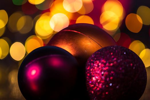 Decorations and ornaments in a colorful Christmas composition isolated on background of blurred lights.