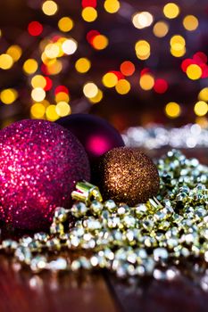 Decorations and ornaments in a colorful Christmas composition isolated on background of blurred lights.