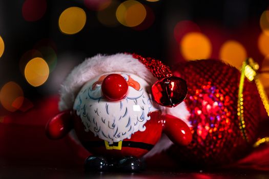 Decorations and ornaments in a colorful Christmas composition isolated on background of blurred lights.