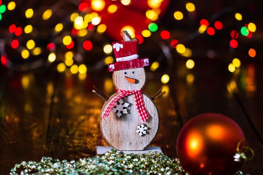 Decorations and ornaments in a colorful Christmas composition isolated on background of blurred lights.