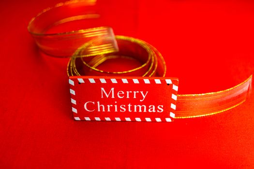 Merry Christmas text wooden sign, decorations and ornaments in a colorful Christmas composition.