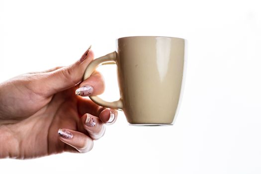 Woman hand holding a cup isolated on white background.