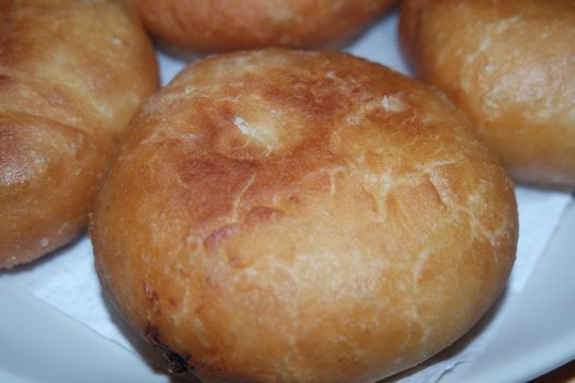 Closeup view of homemade tasty potato bread rolls bun placed over white tissue paper.
