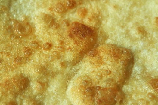 Closeup view of hand made plain bread in oil called paratha roti. Paratha is popular in India, Pakistan and other South Asian countries. Texture for bread.