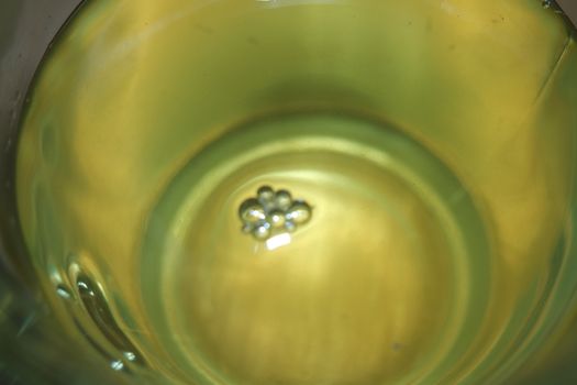 Glass cup having brewed fragrant green tea or qehwa or qahwa on the wooden floor. It is served with sugar or honey and nuts