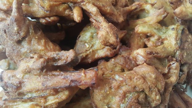 Crispy basin pakora/pakoda or patties are popular indian or pakistani street food snack, served with green salad and sauce. Selective focus of