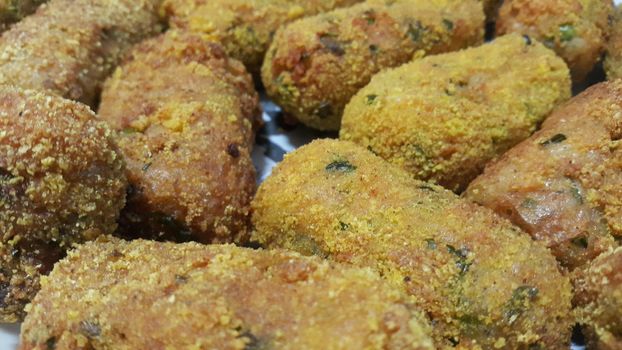 Closeup perspective view of home made spicy and delicious croquettes served with tea or other dishes during parties as fast food.