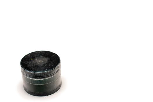 A Used Black Cannabis Grinder With the Lid Closed 