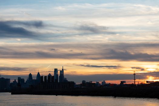 A View of the Philadephia Skyline Over Water On a Dramatic Blue and Orange Sunse