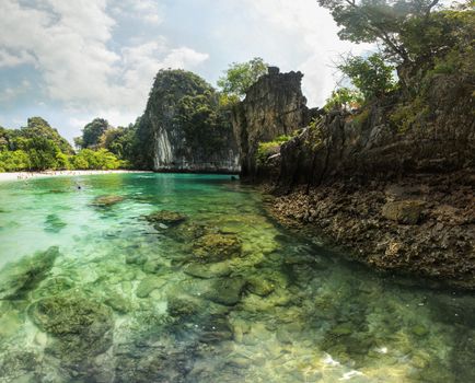 Clear emerald water, rocks visible at sea bottom. Hong Islands bay, Thailand.