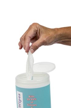 Vertical shot of a female hand pulling out a disinfectant wipe isolated on a white background