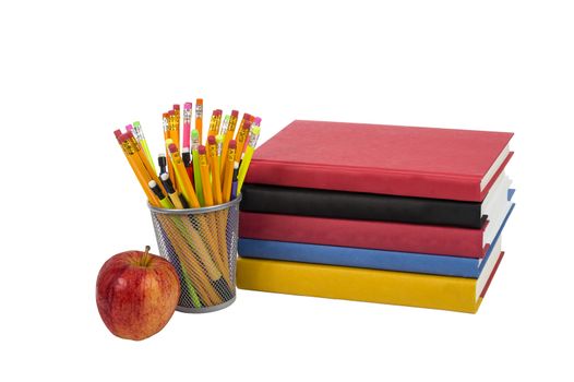 Colorful horizontal photo of a stack of books with an apple and colorful pencils. Isolated on a white background.