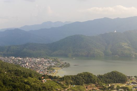 Phewa Lake and Lake Side, city, mountains and lake in Pokhara, Nepal. Panorama and landscape from above.