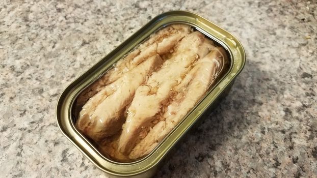 metal can of sardine fish in oil on counter