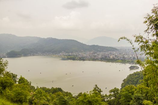 Phewa Lake and Lake Side, city, mountains and lake in Pokhara, Nepal. Panorama and landscape from above.