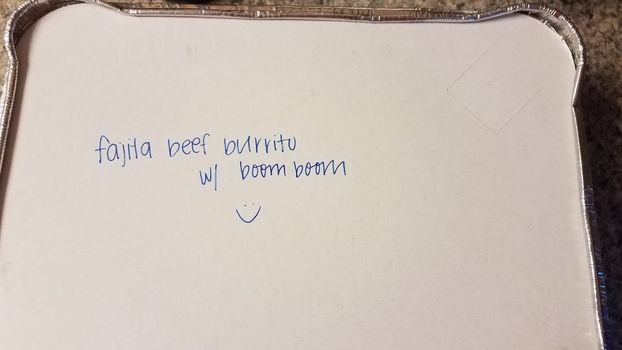 fajita beef burrito with boom boom written on food container