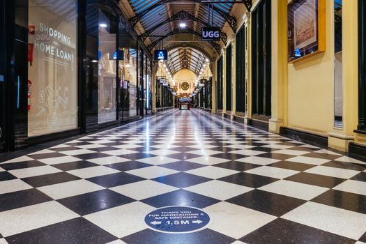 Melbourne, Australia - August 17, 2020: Collins St within Melbourne CBD is quiet and deserted during the Coronavirus pandemic. Melbourne is currently under Stage 4 lockdown and night curfew after a 2nd wave of infections.