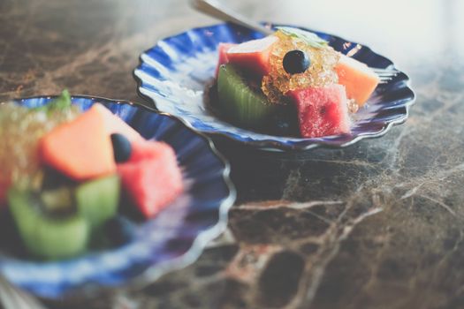 mixed fruit papaya kiwi blueberry watermelon orange in blue dish