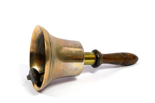 A Vintage Brass School Bell On White Background