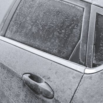 Icy car. Frozen in the ice black car. Hoarfrost. Icy Accumulation. Winter season. Ideal for concepts.