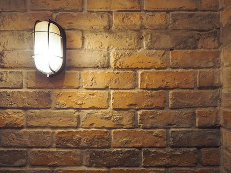 Brick wall old dirty texture background and hanging lamp and yellow light and flare in to camera.