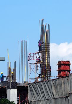 Labor working on construction site that have industry material on high building and have high risk in danger on thier life.