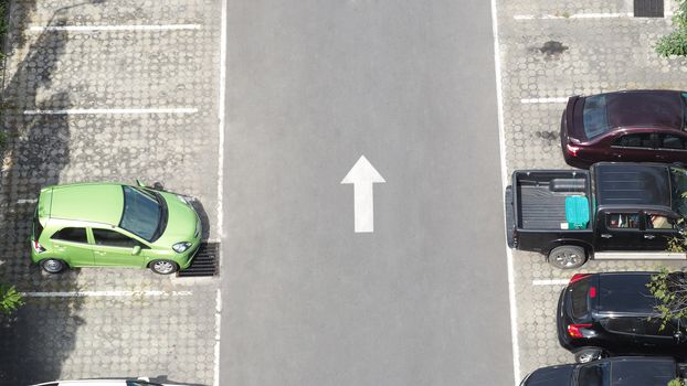 Car parking space and concrete road outdoor and white arrow and top view angle.