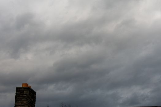 A Brick Chimney on a Cloudy Gray Overcast Sky