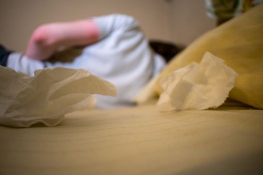 A Young Man in a White Shirt Lying in Bed Sick With Dirty Tissues