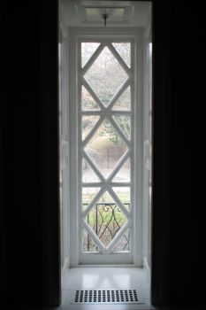 A Long Rectangular White Window With A Diamond Pattern