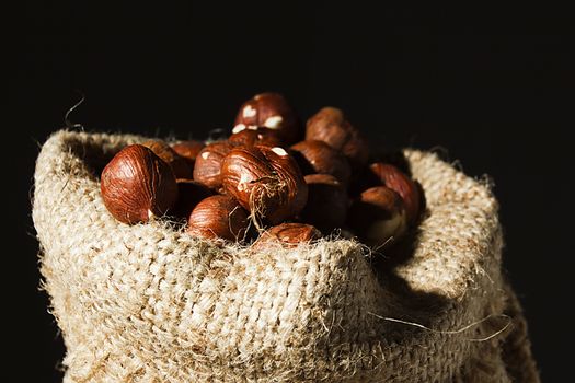 Unpeeled hazelnuts in a bag close up