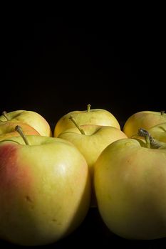 Organic fresh ripe apples on black background