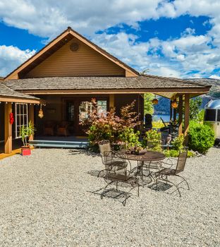 Outdoor cafe on road side close to waterfront of Okanagan lake with view to the mountains