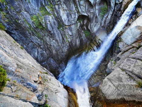 water fall shot from above. Stream running over rocky cliff in Switzerland