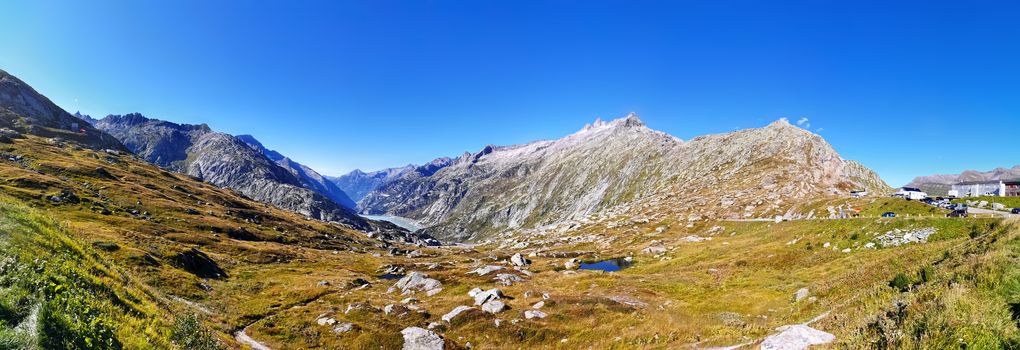 panorama scenery of the swiss alps. Lake at the top of grimsel pass at 2168 meters. Clean air