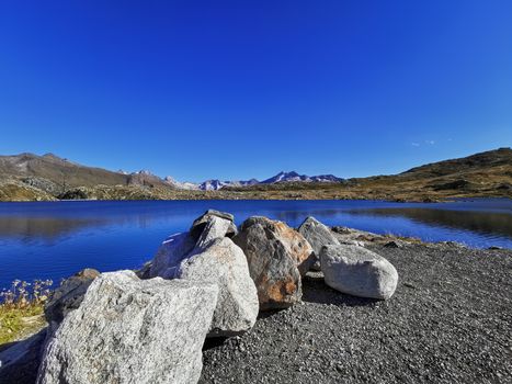panorama scenery of the swiss alps. Lake at the top of grimsel pass at 2168 meters. Clean air