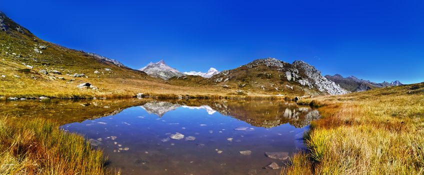 panorama scenery of the swiss alps. Lake at the top of grimsel pass at 2168 meters. Clean air