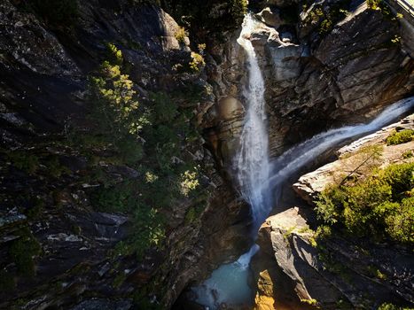 water fall shot from above. Stream running over rocky cliff in Switzerland