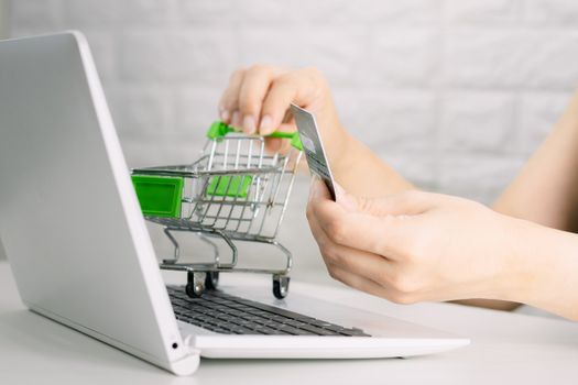 Hands holding credit card on the keyboard online shopping on laptop
