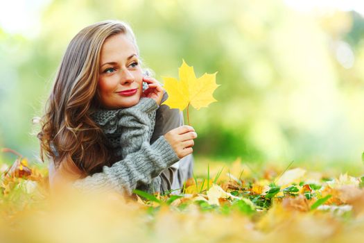 woman portrait in autumn leaf close up