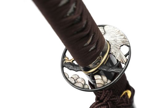 Tsuba is a hand guard of Japanese sword made of steel​  isolated in white background.  Selective focus.