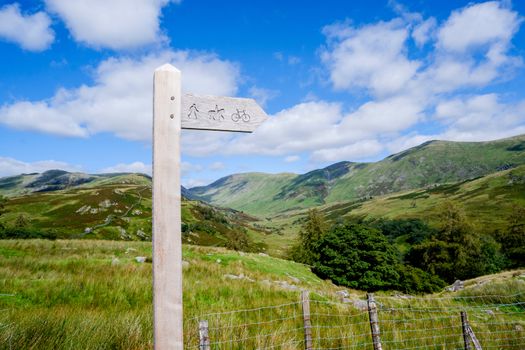 wooden public bridleway sign post on Kirkstone Pass in The Lake District