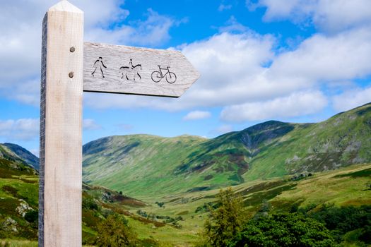 wooden public bridleway sign post on Kirkstone Pass in The Lake District