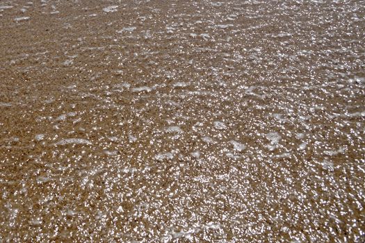 light reflected in water in shallow water, texture for background.